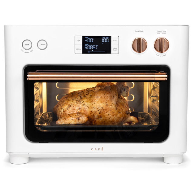 The GE Cafe Couture Smart Toaster Oven features a sleek white design with copper accents, an LED display, and multiple control knobs. It has a transparent door showing a roasted chicken inside, with settings for temperature, cook time, and roast mode.