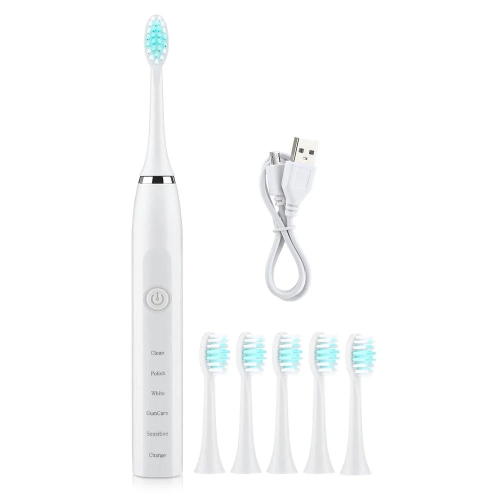 An electric toothbrush with multiple brush head attachments and a USB charging cable.