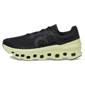 The On Men's Cloudmonster Shoes feature a black upper with a distinctive lime green, cushioned CloudTec sole, providing a unique look and enhanced comfort for running.