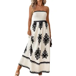 A strapless, white maxi dress with black geometric patterns and a fitted waist. The dress features decorative trim details and is worn with open-toed platform sandals.