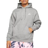 A person is wearing a gray Nike hoodie with a kangaroo pocket and drawstrings, paired with pink abstract-patterned shorts.