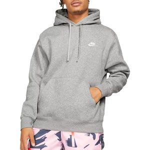 A person is wearing a gray Nike hoodie with a kangaroo pocket and drawstrings, paired with pink abstract-patterned shorts.