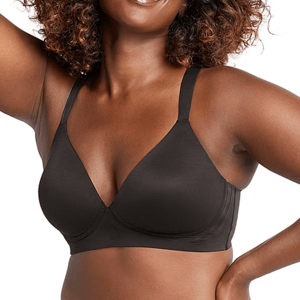 A woman is wearing a black Bali Comfort Wireless Bra, featuring smooth, seamless cups and adjustable straps for support and comfort.
