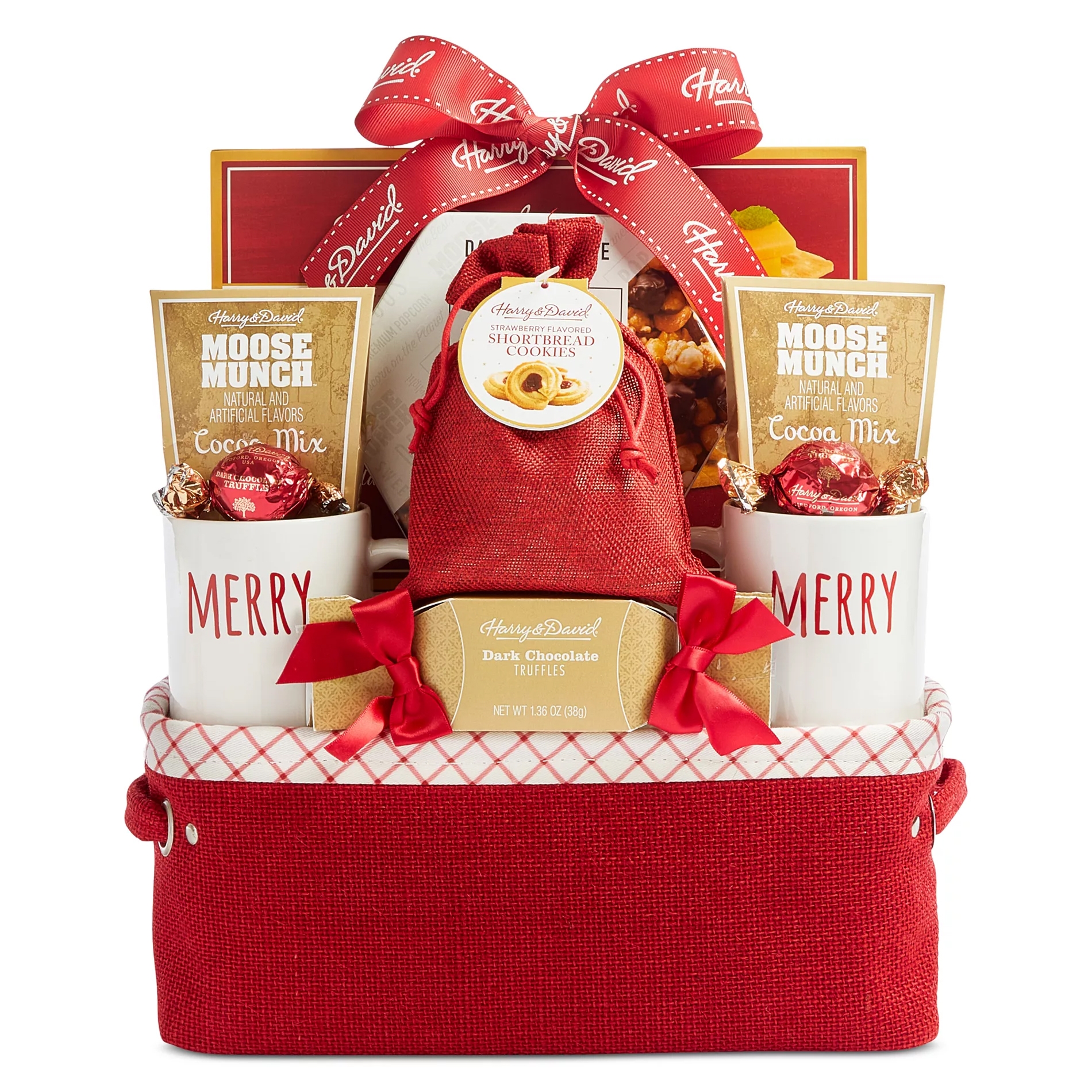 Gift basket with \“Harry & David\“ branding, containing cocoa mix, dark chocolate truffles, strawberry shortbread cookies, and two \“MERRY\“ mugs, all in a red container with a decorative bow.