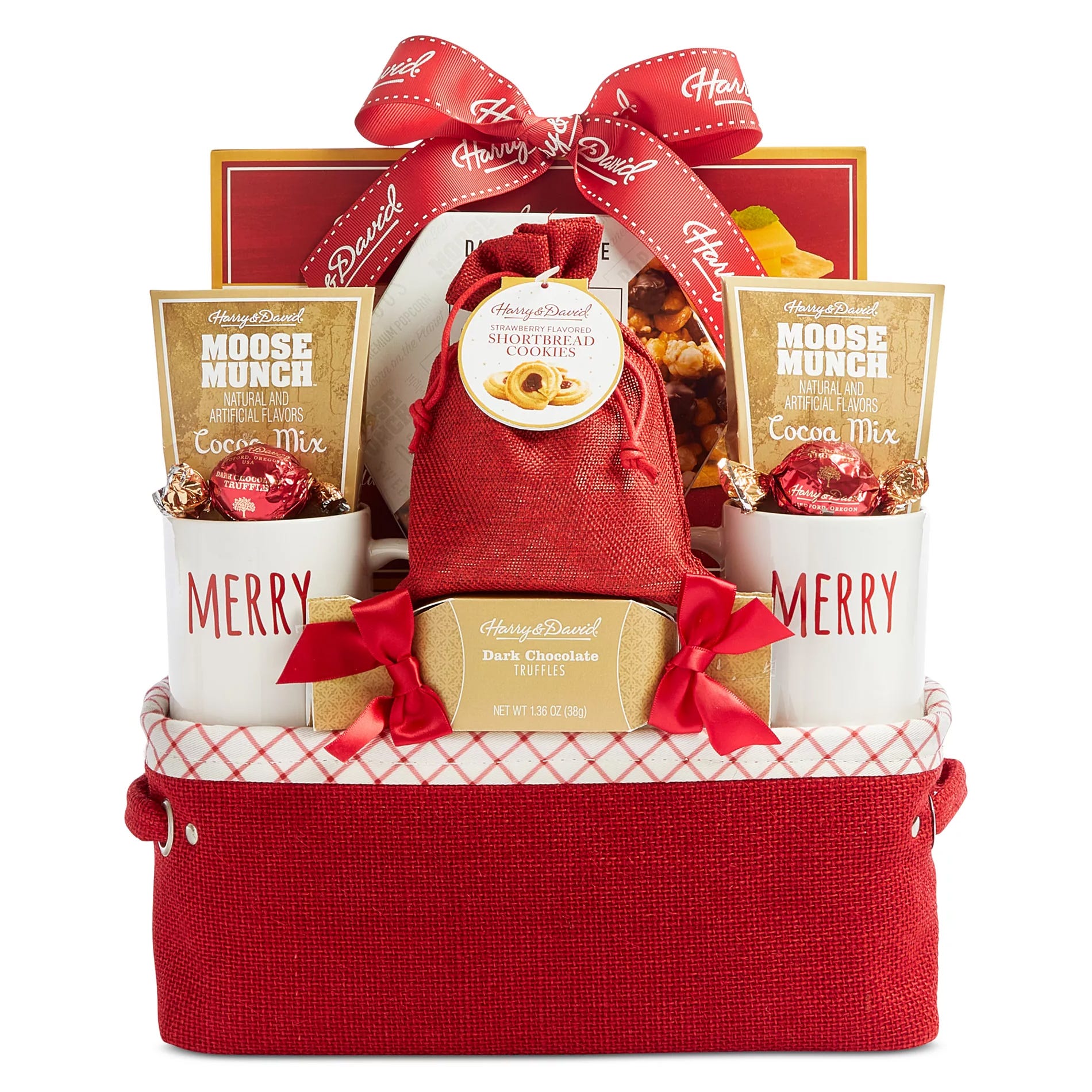 Gift basket with \“Harry & David\“ branding, containing cocoa mix, dark chocolate truffles, strawberry shortbread cookies, and two \“MERRY\“ mugs, all in a red container with a decorative bow.