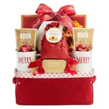 Gift basket with \“Harry & David\“ branding, containing cocoa mix, dark chocolate truffles, strawberry shortbread cookies, and two \“MERRY\“ mugs, all in a red container with a decorative bow.