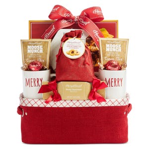 Gift basket with \“Harry & David\“ branding, containing cocoa mix, dark chocolate truffles, strawberry shortbread cookies, and two \“MERRY\“ mugs, all in a red container with a decorative bow.