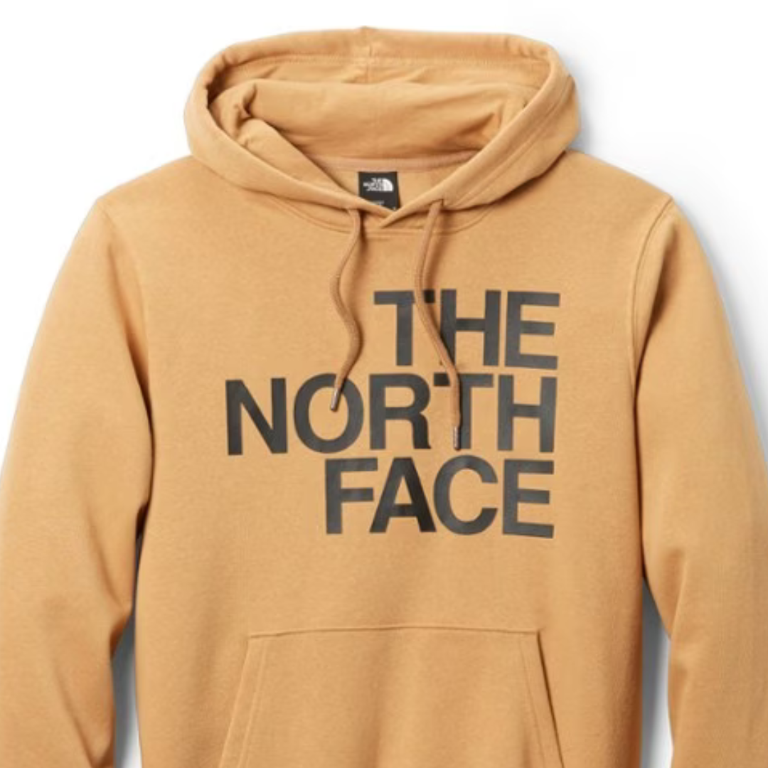 A tan hoodie with the grey logo of The North Face displayed on the front.