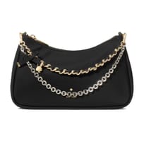 A black handbag featuring dual metallic chains, one in gold and another in silver, with a small lock charm and bow detail near the zipper closure.