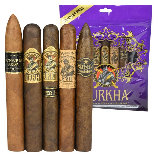 Sampler pack of Gurkha cigars featuring five different varieties with distinct labels, including \“ARCHIVE 1887,\“ \“MASTER SELECT,\“ \“EVIL,\“ and \“NINJA,\“ alongside a purple package.