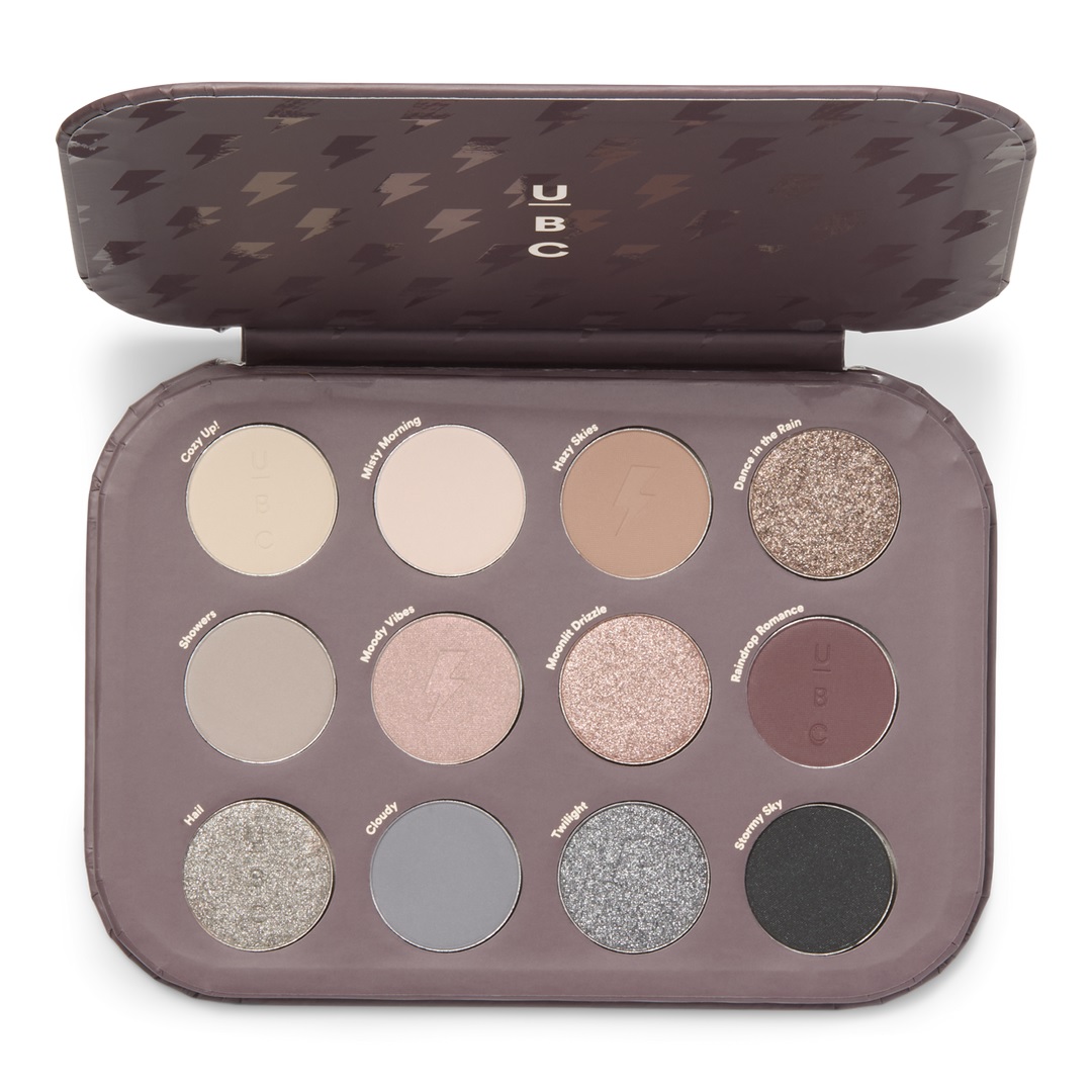 Ulta 12 Pan Eye Shadow Palette features matte and shimmer shades with names like Cozy Up!, Misty Morning, and Rainy Romance. The palette includes neutral, gray, and earthy tones for versatile makeup looks.