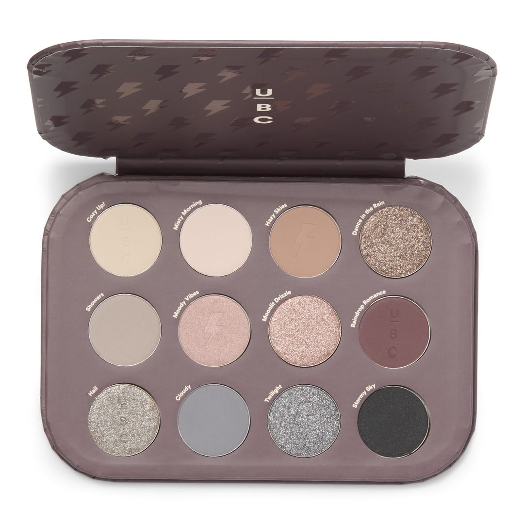 Ulta 12 Pan Eye Shadow Palette features matte and shimmer shades with names like Cozy Up!, Misty Morning, and Rainy Romance. The palette includes neutral, gray, and earthy tones for versatile makeup looks.