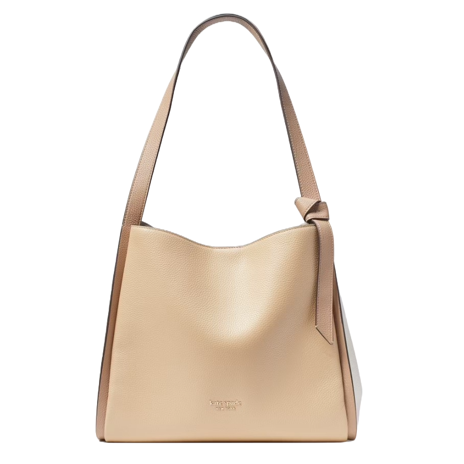A beige leather tote bag with a subtle knot detail on the strap and logo engraving near the bottom center.