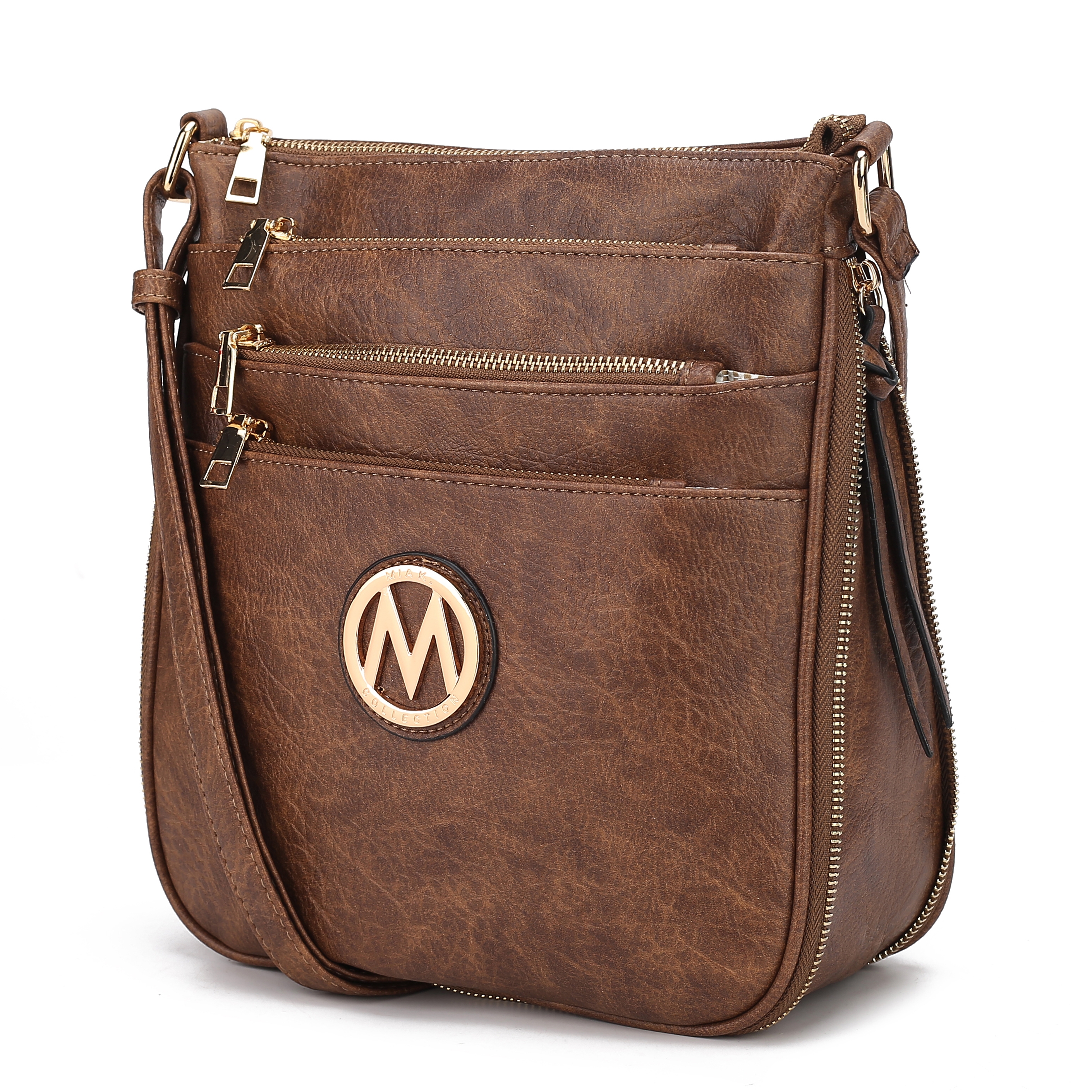 Brown crossbody bag with multiple zippered compartments and an \“M\“ logo on the front.