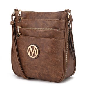 Brown crossbody bag with multiple zippered compartments and an \“M\“ logo on the front.