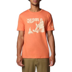 Orange Columbia t-shirt featuring a graphic of a Sasquatch-like figure sitting by a campfire, short sleeves, and Columbia logo on the left sleeve.