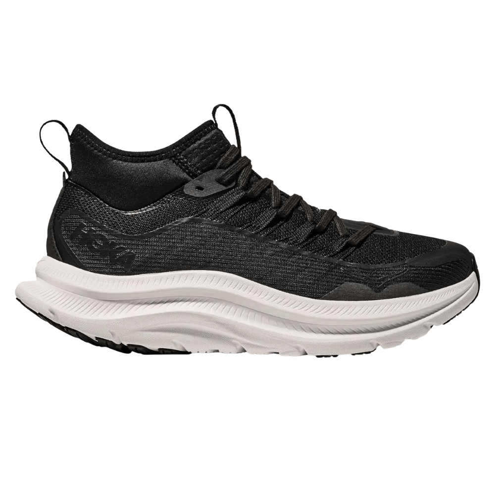 A black athletic shoe with a textured upper and a thick, white, wavy sole, designed for comfort and support.