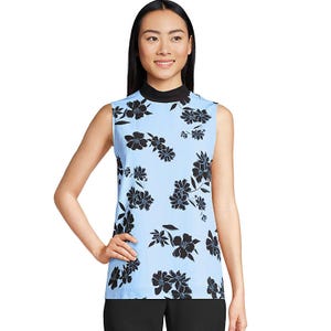 Sleeveless light blue top with black floral print and a black collar, paired with black pants.