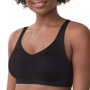 A woman wearing a plain black sports bra.