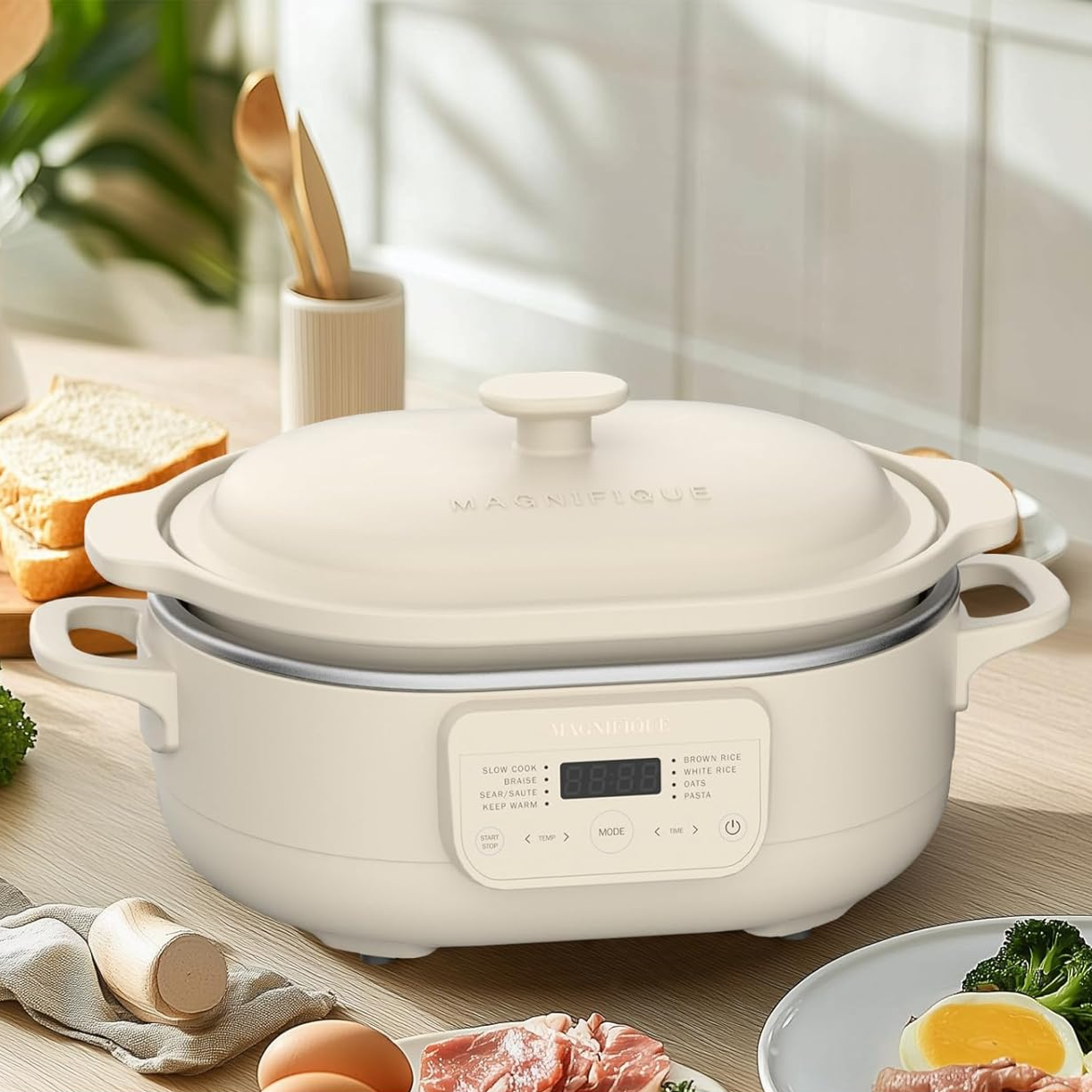 A 4-quart capacity cooking appliance with a digital interface, suitable for tasks like slow cooking and rice preparation, is set on a kitchen counter surrounded by food items.