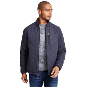 A man is wearing a quilted jacket in a dark color with a zippered chest pocket, over a gray sweater and jeans.