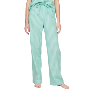 A pair of mint green striped pajama pants with a relaxed fit and waistband tie, worn by a person standing barefoot.