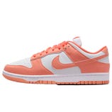 A Nike Dunk Low sneaker in peach and white colorway, featuring a white base with peach overlays, laces, and a swoosh, on a white midsole and peach outsole.