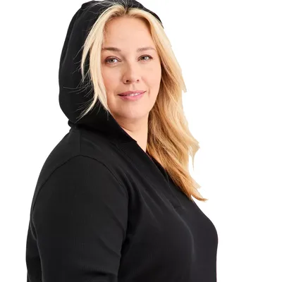 A person wearing a black hooded garment.