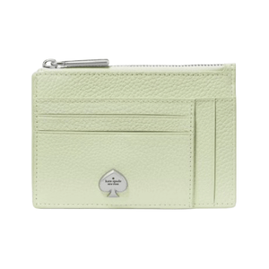 A light green leather card holder with multiple card slots, a zippered compartment, and a metal spade logo in silver at the front.