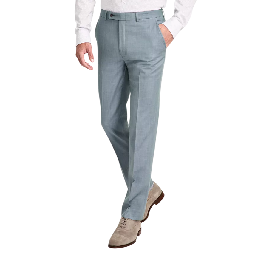 A man is wearing light blue dress pants with a white shirt. He's also wearing grey suede dress shoes with brown soles.