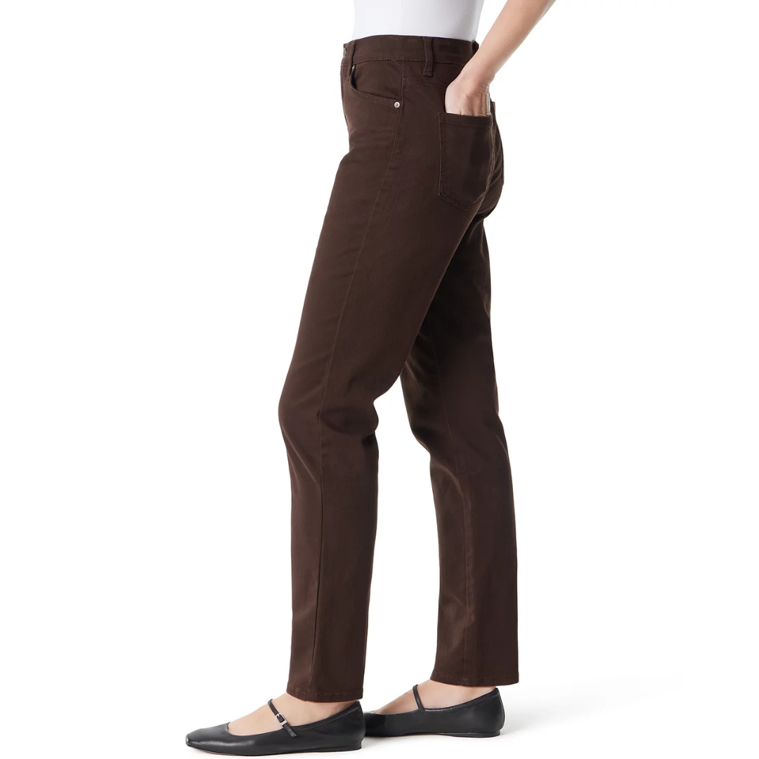 A person is wearing dark brown straight-leg jeans paired with black ballet flats. The jeans have a classic five-pocket design.