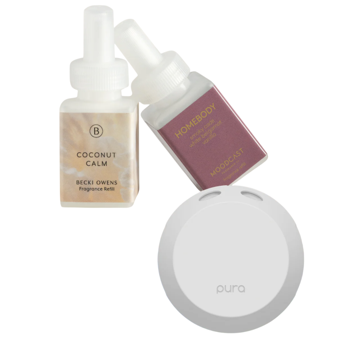 Two fragrance refills, \“Coconut Calm\“ by Becki Owens and \“Homebody\“ by Moodcast, are shown alongside a white Pura diffuser.