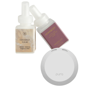 Two fragrance refills, \“Coconut Calm\“ by Becki Owens and \“Homebody\“ by Moodcast, are shown alongside a white Pura diffuser.
