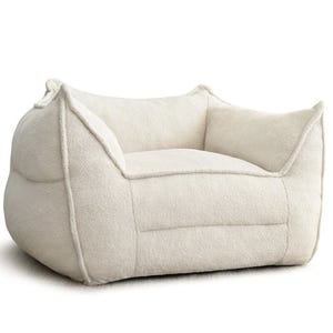 A 43-inch boucle bean bag chair with a thick, cozy texture, featuring a boxy shape and raised armrests for a comfortable and relaxed seating experience. The light color and plush design add a modern touch to any space.