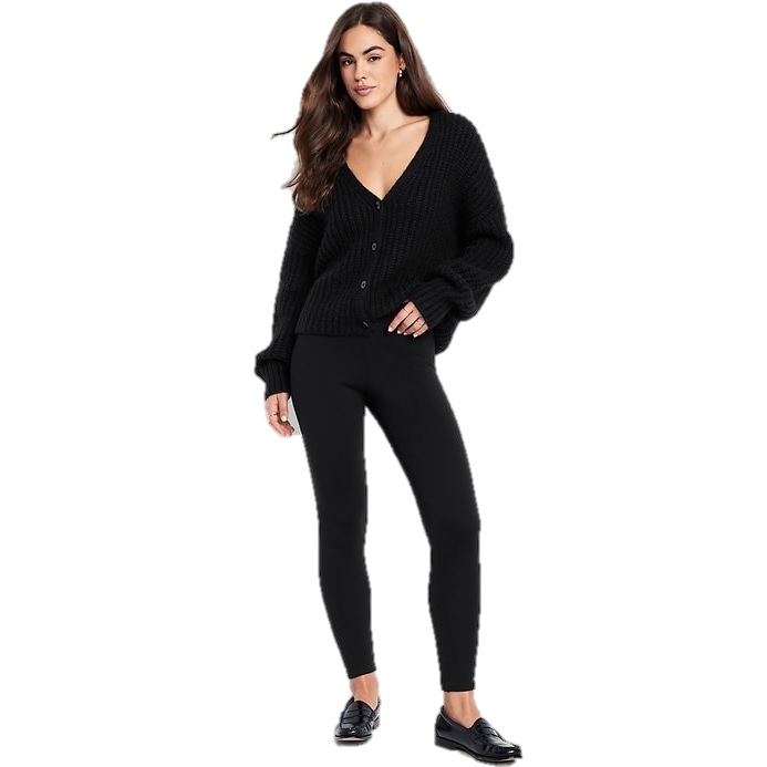 A woman is wearing a black cardigan, black leggings, and black loafers.
