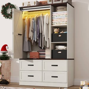 The August Grove Armoire is a white wooden wardrobe with a sliding barn door and includes a hanging section with LED lights, shelves for folded clothes, decorative boxes, and four lower drawers. Top features luggage-style boxes, complemented by seasonal decor.