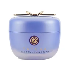 Tatcha The Dewy Skin Cream in a round, light purple container with a gold emblem on top.