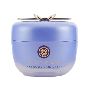 Tatcha The Dewy Skin Cream in a round, light purple container with a gold emblem on top.