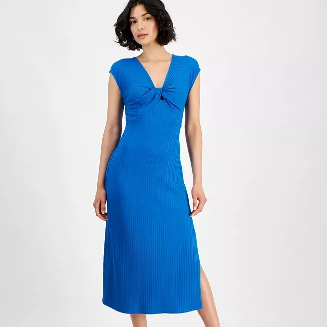 A blue midi dress with a ribbed texture features a twist-front detail at the chest, short sleeves, and a side slit.