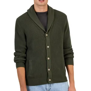 A person is wearing an olive green shawl-collar cardigan with visible buttons and front pockets, paired with a dark shirt and light jeans.