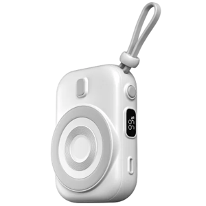 A compact white portable device with a wrist strap, featuring a circular charging pad and a small display screen showing \“55%\“.