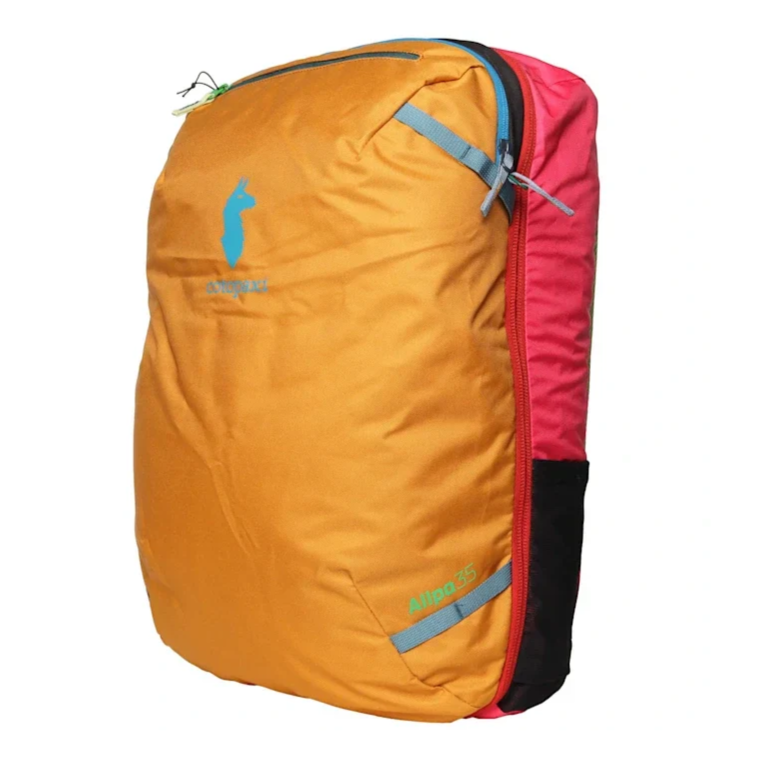 A colorful Cotopaxi Allpa 35 travel backpack in yellow and pink with a blue llama logo and gray accents.