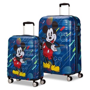 Two hard-shell suitcases feature a colorful design with a cartoon character. The smaller suitcase has four wheels, and the larger one is similar in style. Both are by American Tourister.