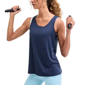 A woman in a navy blue tank top and light blue leggings is holding a jump rope.