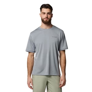 A man wearing a light grey Columbia short-sleeve t-shirt and light pants, standing against a plain white background.