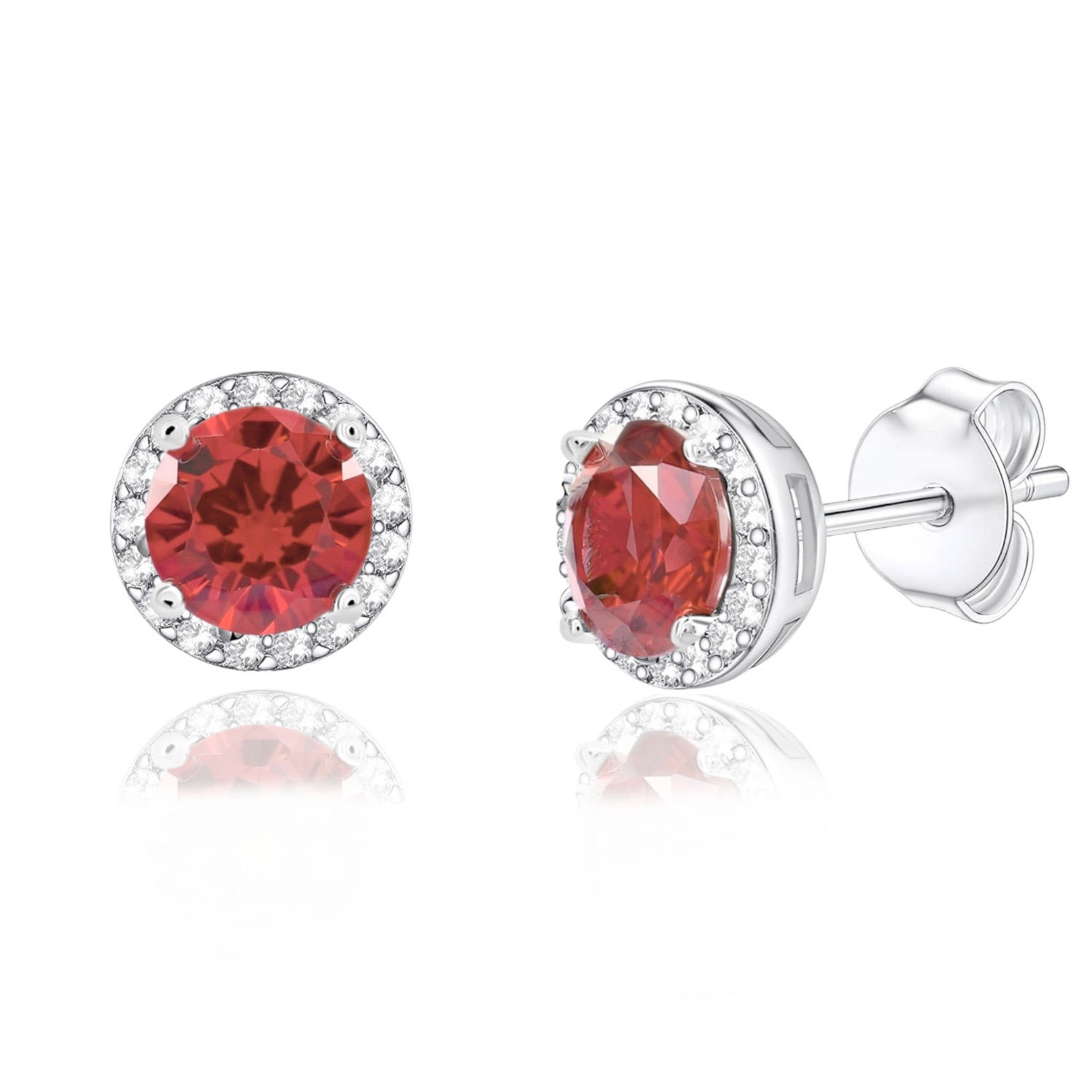 A pair of round red gemstone stud earrings encircled by small clear stones, set in a silver-toned metal.