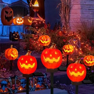 A collection of illuminated jack-o'-lantern decorations set up for Halloween.