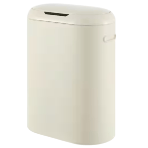 A beige trash can with a sleek, oval design, featuring a closed lid and side handle.