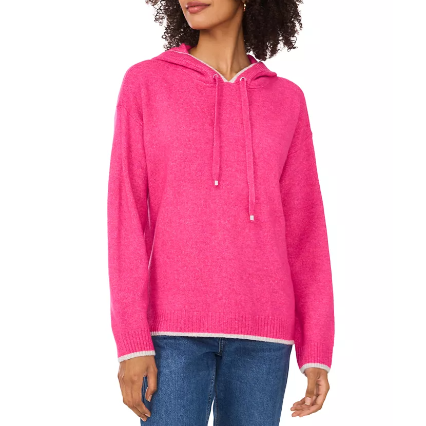 A bright pink hooded sweater with a drawstring neckline and long sleeves, featuring ribbed cuffs and hem. It is paired with blue jeans.