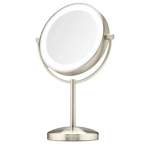 The Conair Double-Sided LED Vanity Mirror is a tabletop mirror with a brushed nickel finish, featuring dual magnification and LED lighting for enhanced visibility.